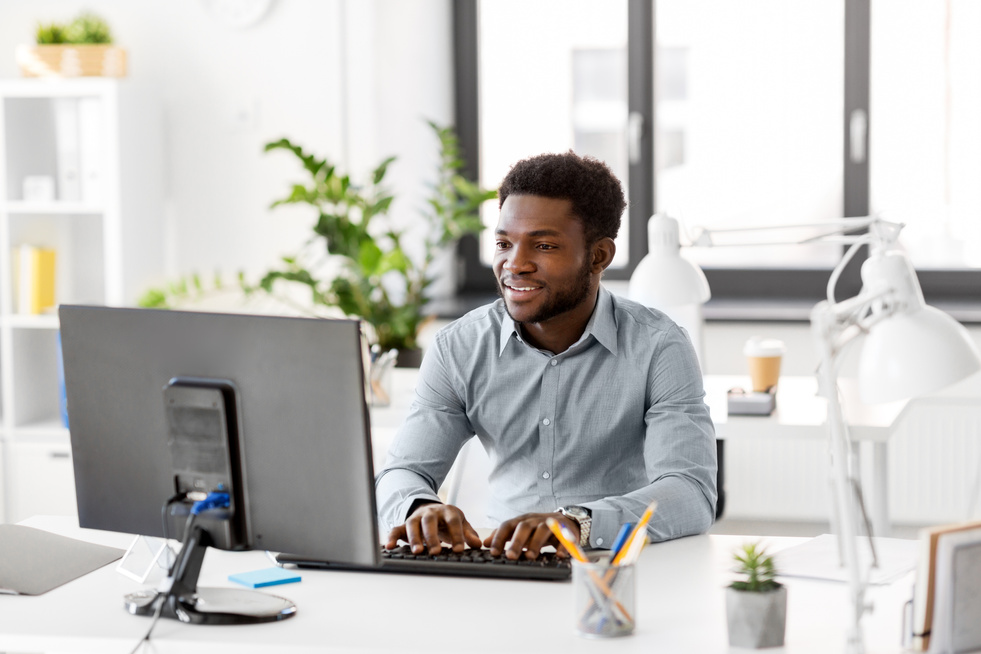 African Businessman with Computer at Office